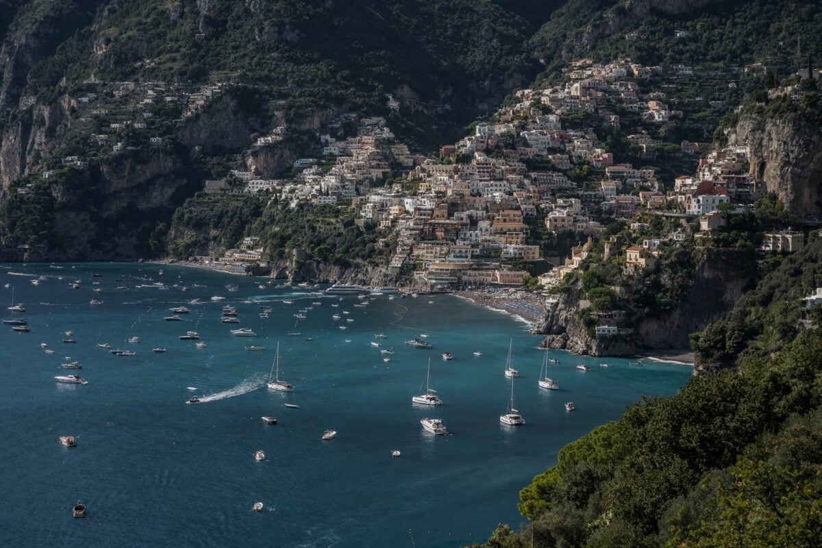 Positano y su bahía con barcas vistos desde la carretera